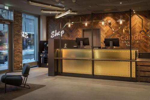 a store lobby with a checkout counter and a chair at Scandic Lillestrøm in Lillestrøm