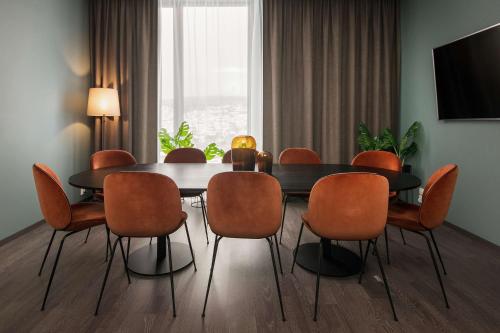 a dining room with a table and chairs at Scandic Lillestrøm in Lillestrøm