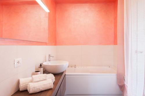 a bathroom with a sink and a bath tub at Terrace of Wally - Apartment With Pool in Torri del Benaco