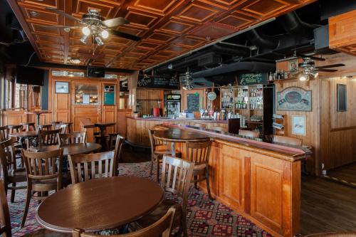 a restaurant with tables and chairs and a bar at Scandic Mikkeli in Mikkeli