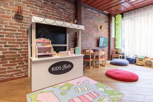 a childrens play area with a kids station in a brick wall at Scandic Rauma in Rauma