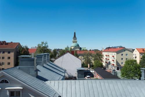 an aerial view of a city with a clock tower at Scandic Oulu Station in Oulu