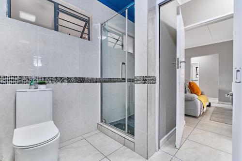 a bathroom with a toilet and a walk in shower at Luxury Living at Canvas 82 Unit 129 in Four Ways