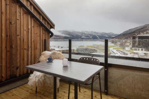 a table and chairs on a balcony with a view at Scandic Voss in Vossevangen