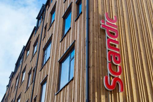 a sign on the side of a building at Scandic Voss in Vossevangen