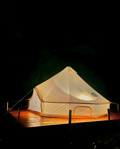 a white tent is lit up at night at Kamp Obası Oğuz in Oghuz