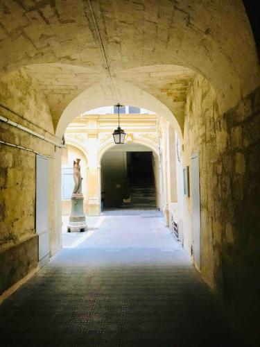 un couloir vide avec une statue au milieu d'un bâtiment dans l'établissement Studio in historical monument in city center, à Montpellier