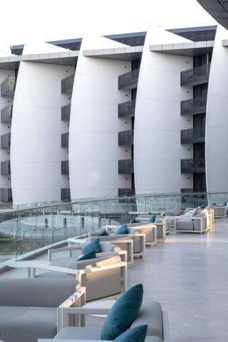 a building with white chairs and blue pillows at Jumeirah Saadiyat Island Abu Dhabi in Abu Dhabi
