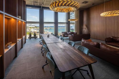 a conference room with a long table and chairs at Scandic CPH Strandpark in Copenhagen