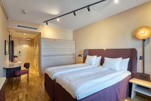 a bedroom with a large bed in a room at Scandic Kiruna in Kiruna