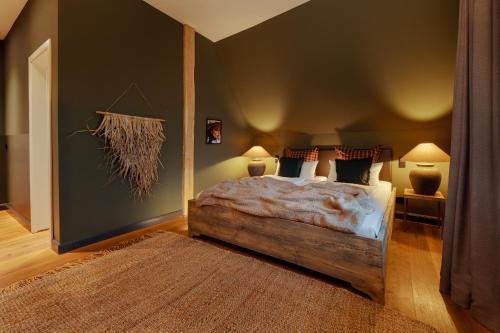 a bedroom with a bed and two lamps and a rug at Hof Bissee Nature Hideaway Guesthouse "Corn Barn" in Bissee