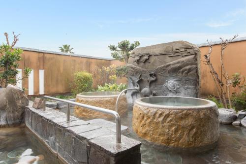 a fountain in the middle of a yard at Ibusuki Kokoronoyado in Ibusuki