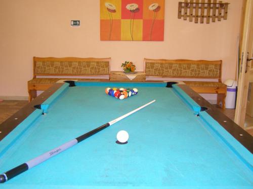 a pool table with a ball in a room at Penzión pod Barancom in Žiar