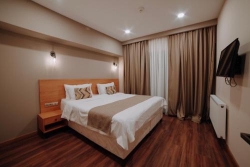 Postel nebo postele na pokoji v ubytování Bakuriani Inn