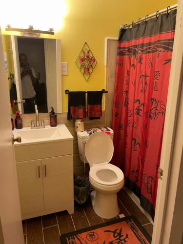 a bathroom with a toilet and a sink and a mirror at Dayton get away in Dayton