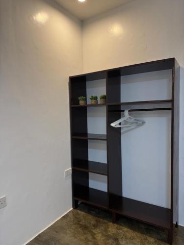 a black and white shelf in a room at NUTMEG Cottage Siargao- Private room in General Luna