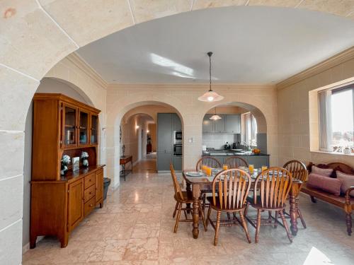 a kitchen and dining room with a table and chairs at Villa Fieldend - Gozo Holiday Home in Għarb