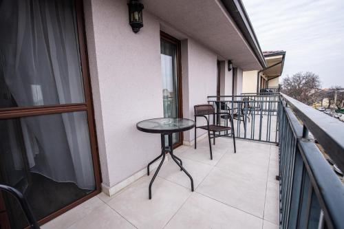 a balcony with a table and chairs on it at Nora Prestige in Timişoara