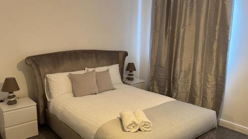 a bedroom with a bed with two towels on it at Big Confort, Shared House in Bristol