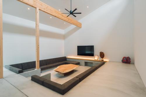 a living room with a couch and a tv at ACOA Villa Takashima in Takashima