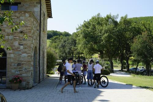 a group of people standing outside of a building at Agriturismo Colle Casini Cortesi in Caldarola