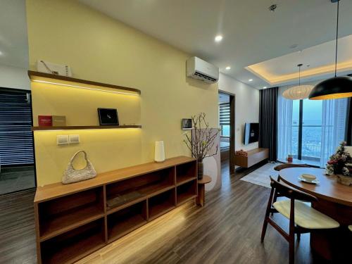 a living room with a table and a dining room at Na Mit HomeStay in Hai Phong