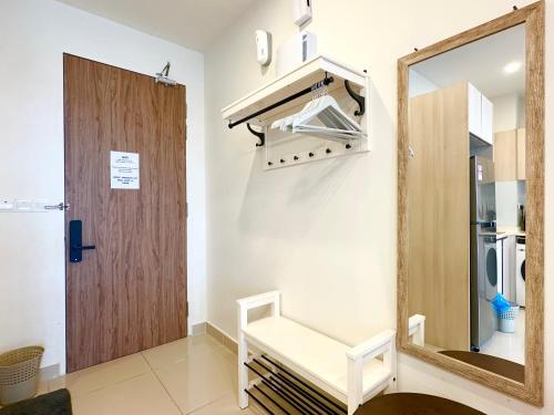 a dressing room with a mirror and a door at The Shore Premier Suites by Sunset Seaview Vacation Condos in Kota Kinabalu