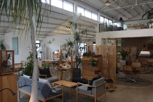 a room filled with lots of furniture and plants at Lin Yin Art Hotel Shanghai（Pudong airport） in Shanghai