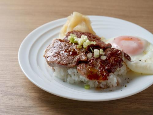 a plate of food with meat and eggs and rice at Hotel Vista Osaka Namba in Osaka