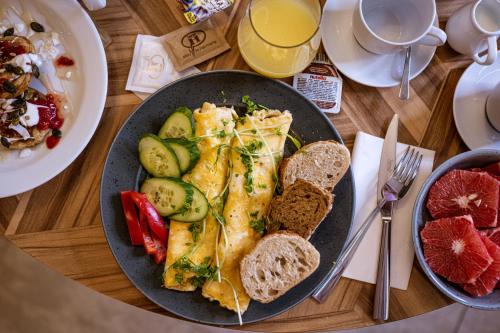 a table with a plate of food with bread and toast at Harmony Club Hotel in Ostrava