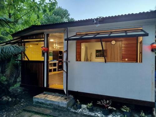 a small house with a large glass door at Faré TIAREI in Tiarei