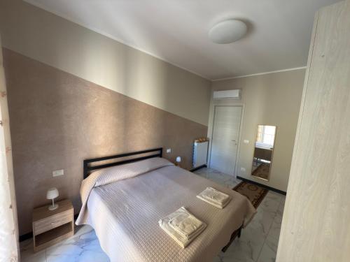 a bedroom with a large bed and a wall at Casa Mare in Rapallo