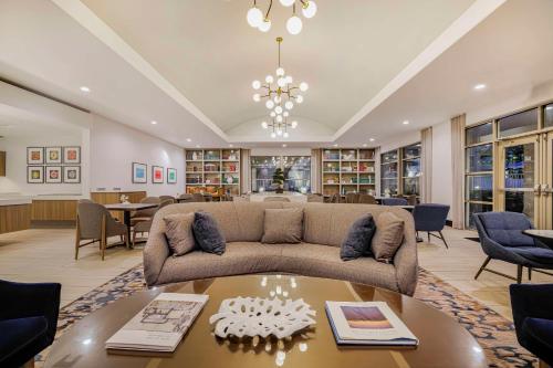 a living room with a couch and a table at Homewood Suites by Hilton Plano-Richardson in Plano