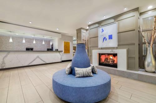 a lobby with a large blue vase on the floor at Homewood Suites by Hilton Plano-Richardson in Plano