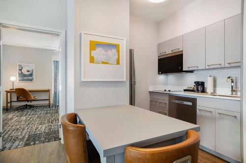 a kitchen with a table and chairs in a room at Homewood Suites by Hilton Plano-Richardson in Plano