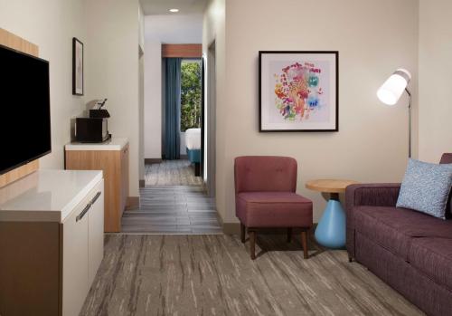 a living room with a couch and a table at Hilton Garden Inn Shreveport in Shreveport