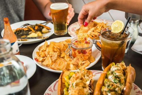 a table topped with plates of food and drinks at Motto by Hilton Washington DC City Center in Washington