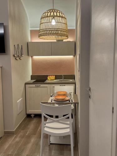 a small kitchen with a table and a chair at RC Sardinia in Sorso