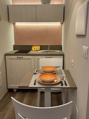 a kitchen with a table with a plate of food on it at RC Sardinia in Sorso