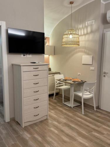a kitchen and dining room with a table and a tv at RC Sardinia in Sorso