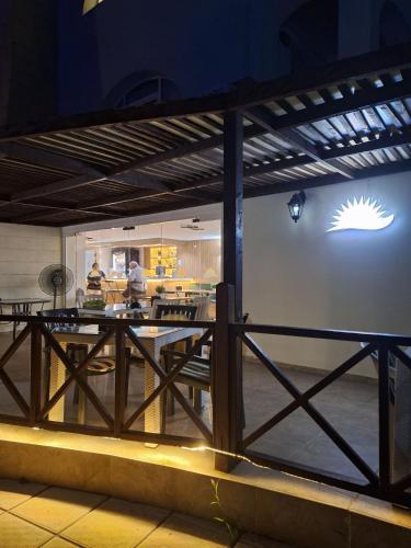 a dining room with a table and a fence at Charming Kalecik Apartment with Shared Pool and Free Parking in Kalecik