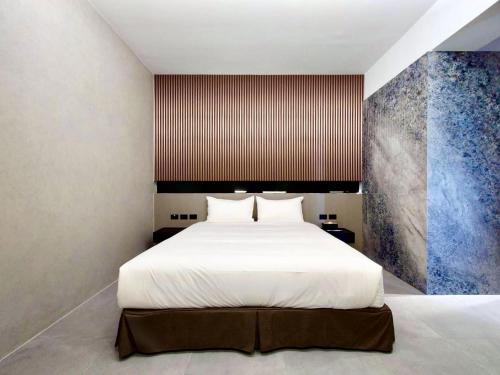 a bedroom with a large white bed in it at Anchorage Lodge in Jian