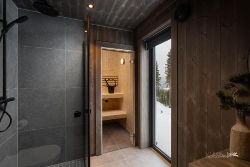 a bathroom with a shower and a glass door at Nesfjellet in Nes i Ådal