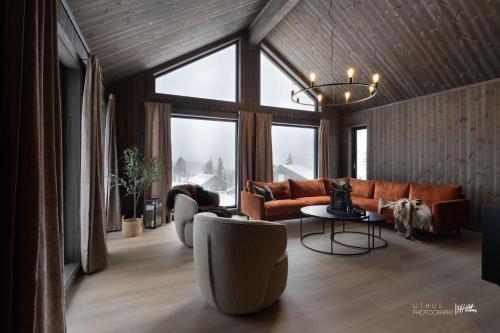 a living room with a couch and a table at Nesfjellet in Nes i Ådal