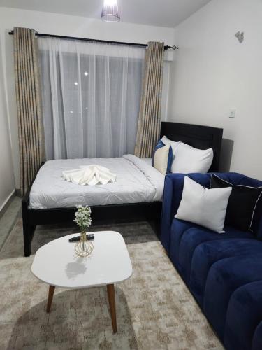 a living room with a couch and a table at Comfort and charm in Nairobi