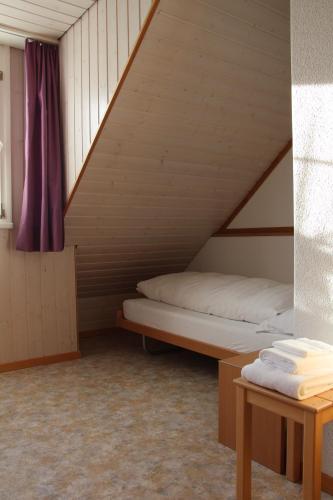 a room with two bunk beds in a attic at Wirtshaus Rütihof in Gränichen