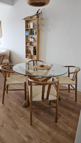 a dining room with a glass table and chairs at Monte View Apartments in Ulcinj