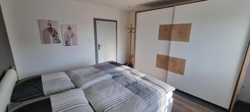 a bedroom with a bed and a sliding glass door at FeWo Süß in Hahnbach