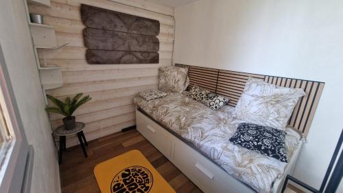 a small room with a couch with pillows on it at Appartement seignosse le penon in Seignosse