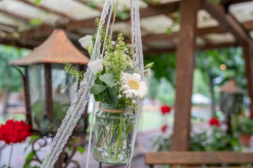 a vase filled with flowers hanging from a chain at Wirtshaus Rütihof in Gränichen